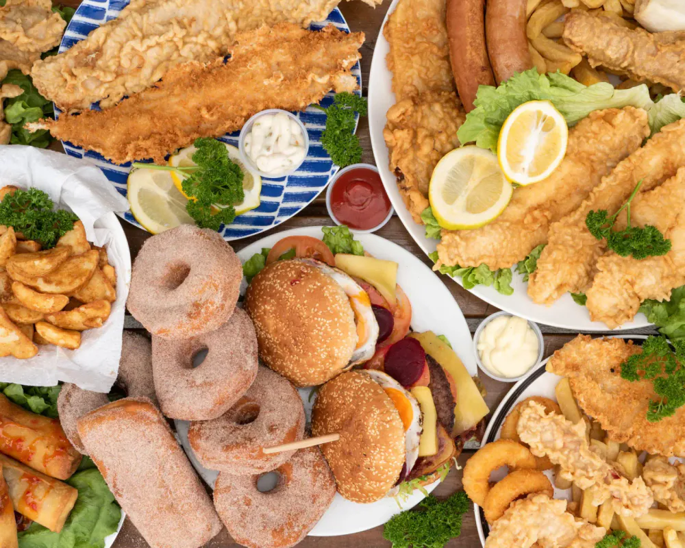 Fried fish, chicken tenders, sliders, fries and doughnuts served with sauces and lemon.