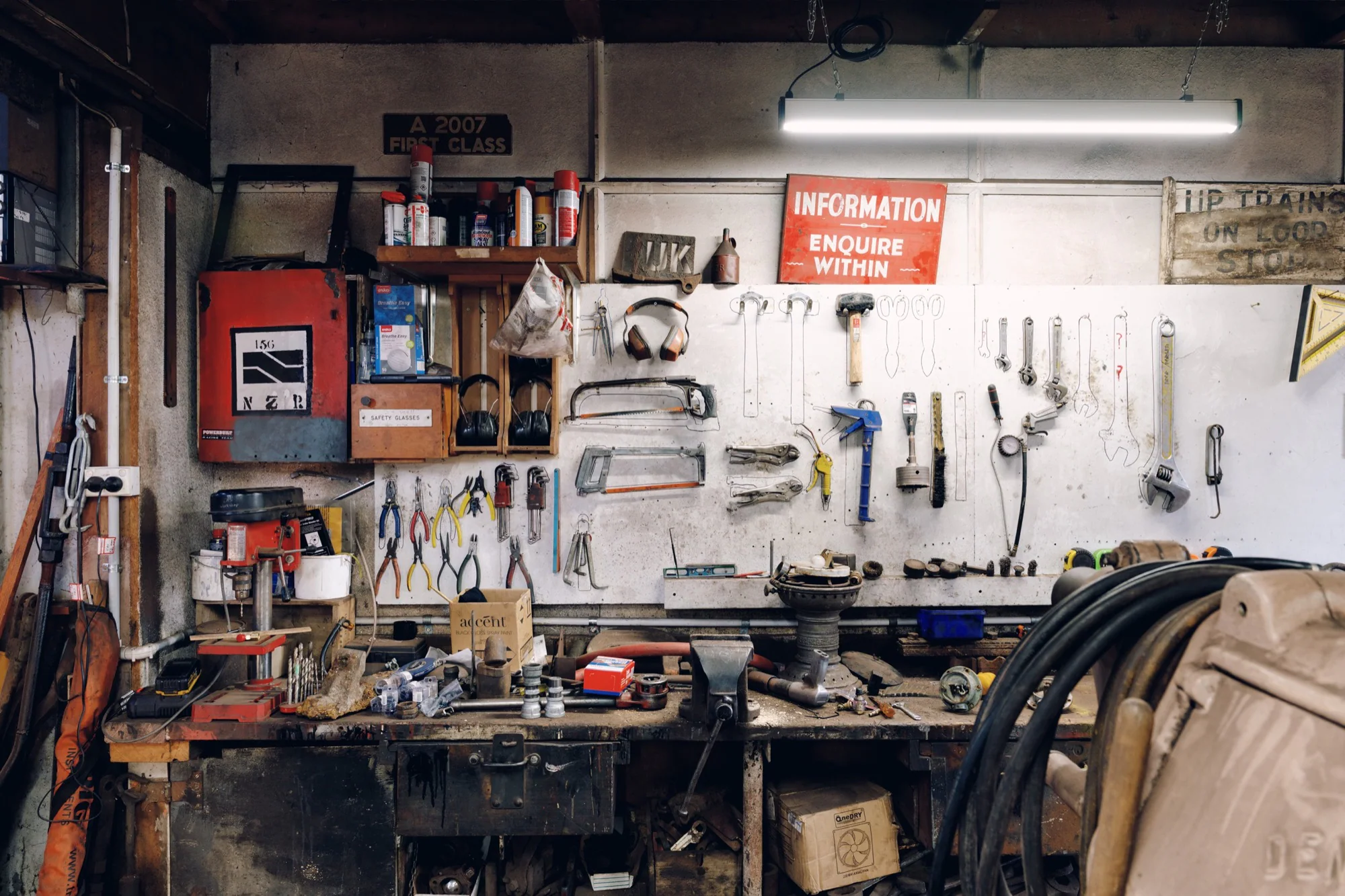 A railway workshop bench and tool wall arranged around an active work area