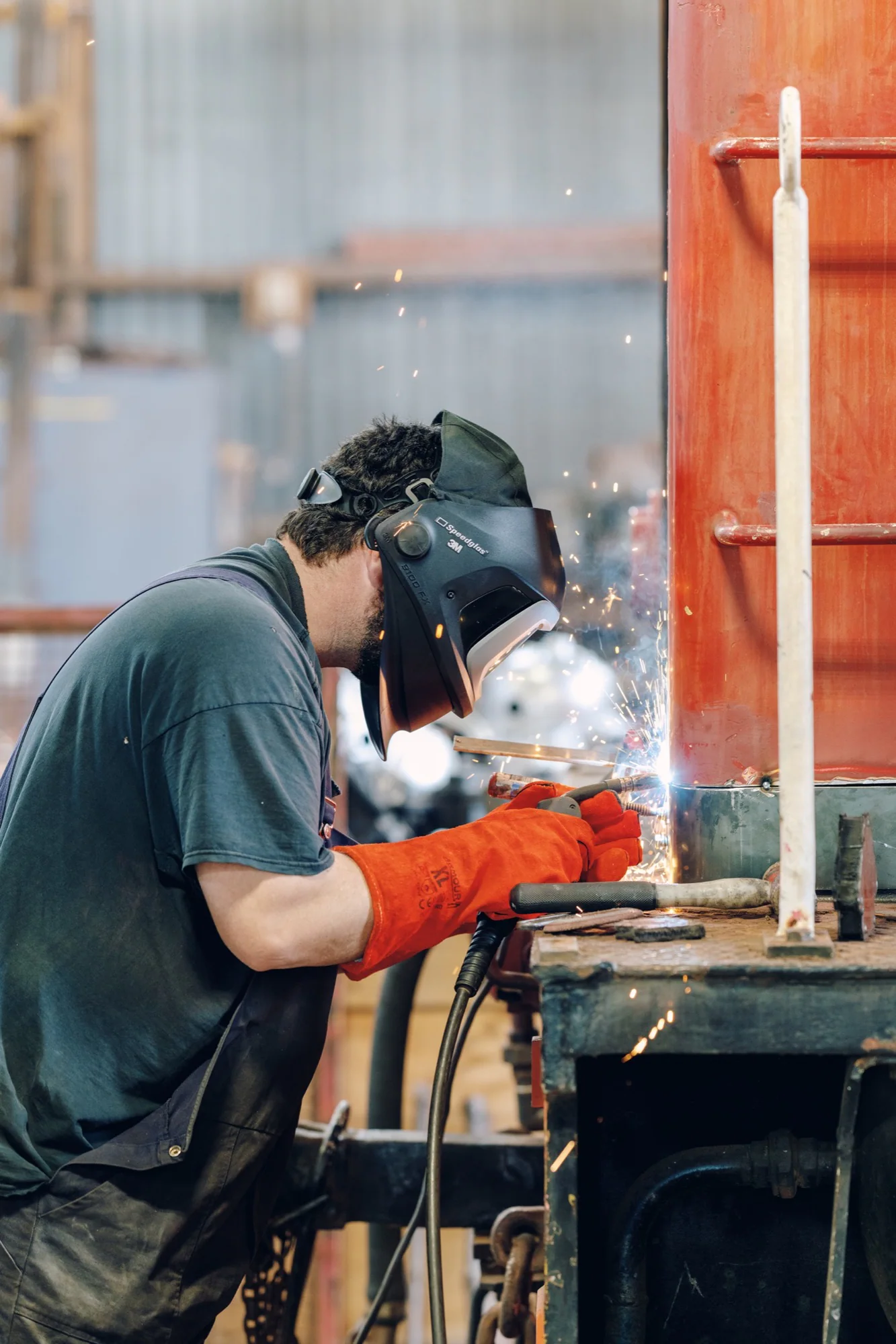 Welder at work on railway equipment during a Canterbury commercial photography shoot